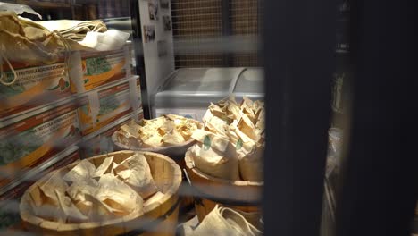 pile of boxes and bags of nuts in wooden buckets enclosed to protect them in a metal grating