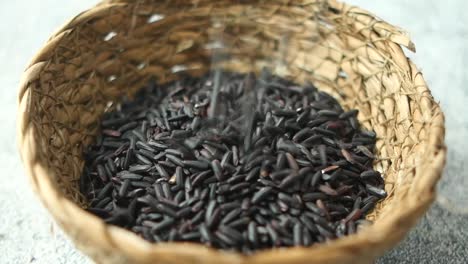 black rice in a straw basket