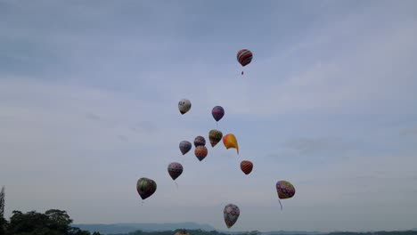 aerial view of colorful balloon festival with cloudy sky on the background