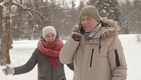 happy senior couple enjoying a snowy day