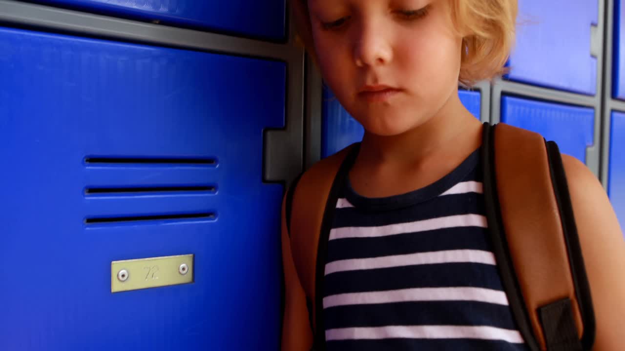 Schoolgirl using mobile phone in locker room 4k
