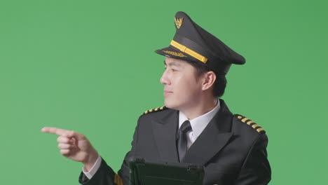 smiling pilot in uniform pointing