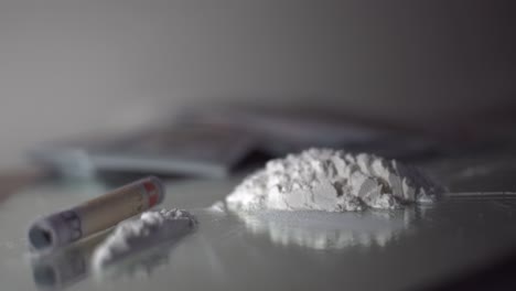 drugs and money isolated scene dramatic rack focus white powder and cash