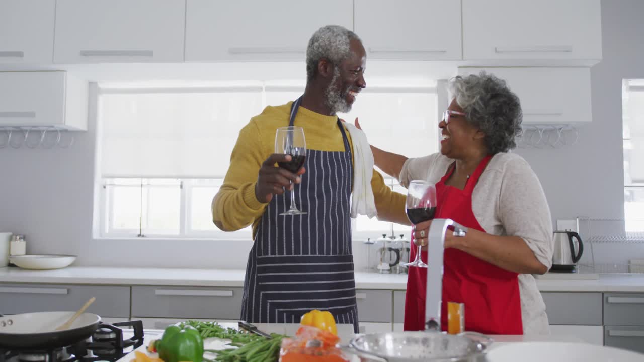 A senior African american couple cooking at home. Social distancing in quarantine