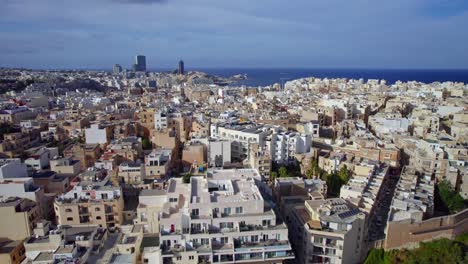 Dynamic-Fast-Aerial-over-Sliema-City-Buildings,-Malta