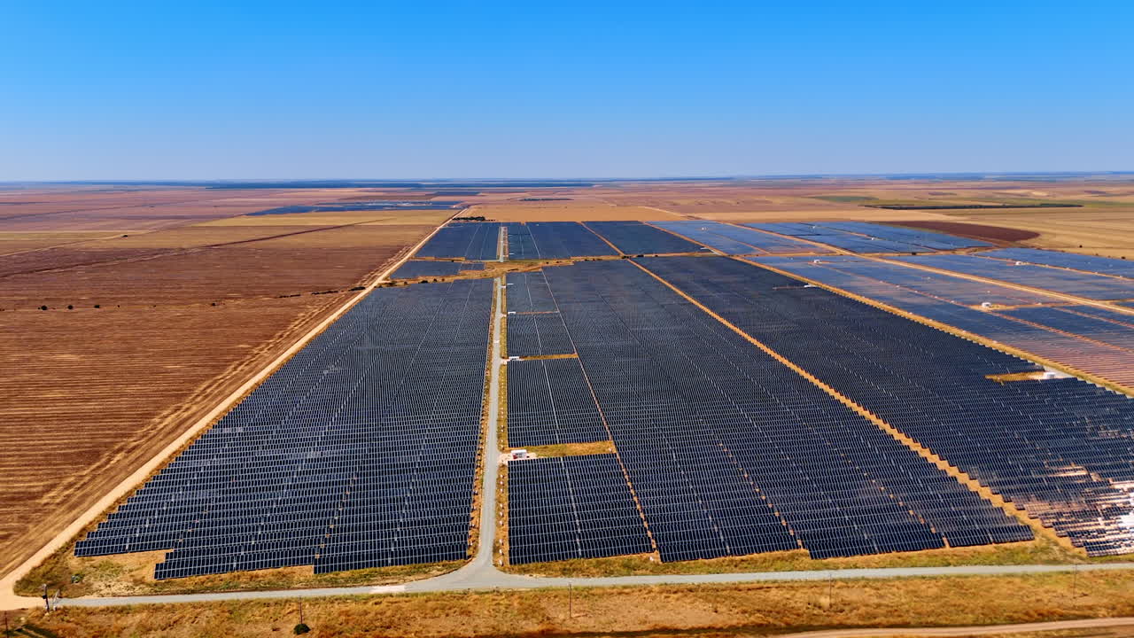 Aerial view of large solar power station. Endless rows of solar panels in Romanian fields producing renewable energy