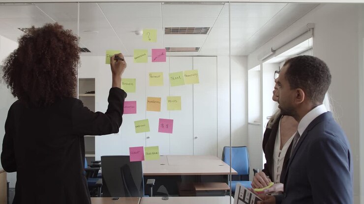 Young business woman writing on sticky notes