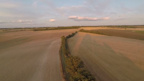 desplazamiento lento de 360 grados para mostrar un paisaje abierto de tierras de cultivo que termina con una toma de una hermosa puesta de sol de verano