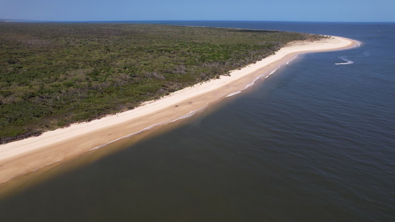 Sandy Beach With Vegetated Campground In Inskip Peninsula, Queensland, Australia. aerial shot