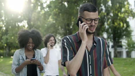hombre barbudo alegre hablando en el teléfono inteligente