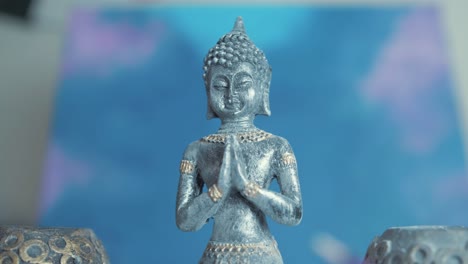 incense burns in front of buddha statue. slider shot track in