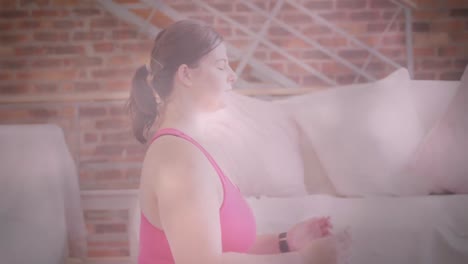 Animation-of-flickering-lights-over-woman-exercising-and-meditating-with-eyes-closed-at-home