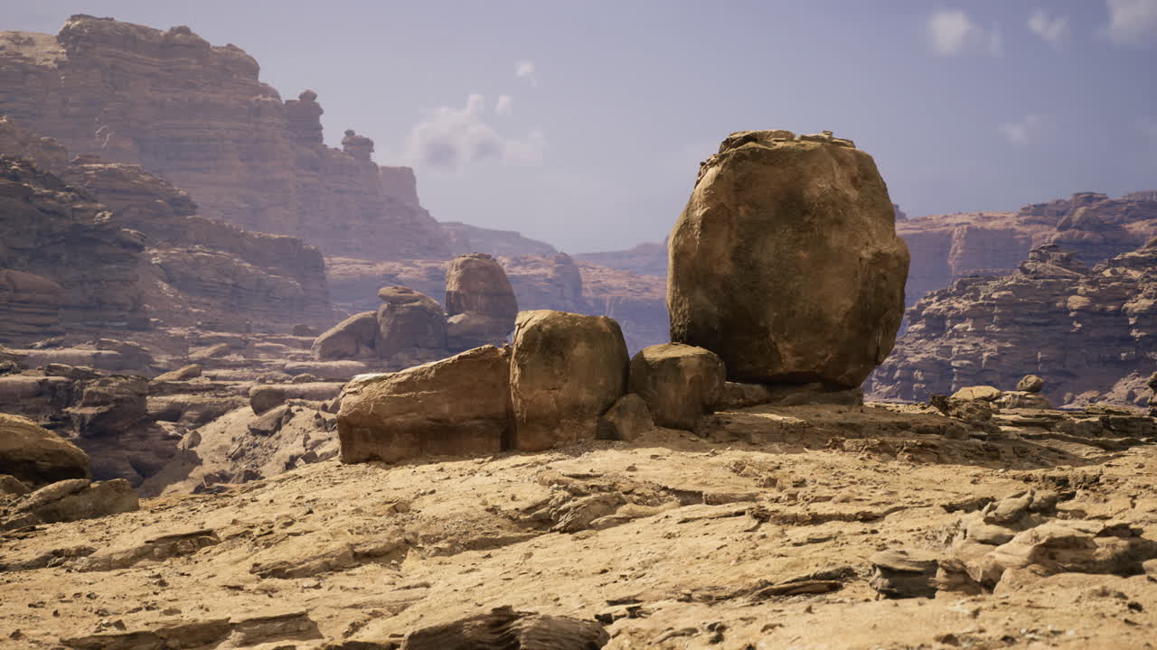 Large boulder formation in a rugged desert landscape under clear sky