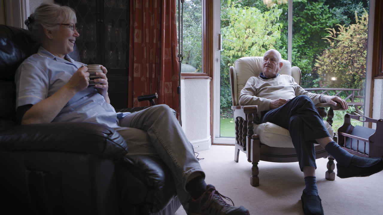 Elderly care: A conversation between a nurse and an elderly man in a comfortable home setting
