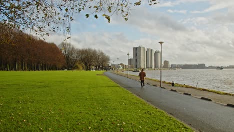 older man in retro clothing running in a city park