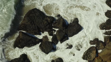 top down spectacular view of ocean rock around when clear sea water ripple on the space in center