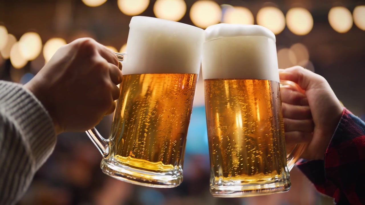 Due mani che brindano con boccali di birra dorata