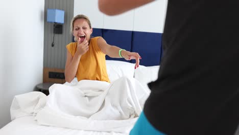 woman's morning mood shift from yawn to laughter in bed