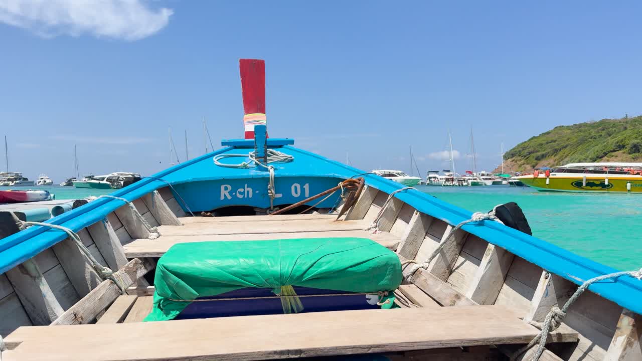 A vibrant boat ride through turquoise waters in Chalong Bay, capturing serene landscapes and clear skies in Phuket, Thailand