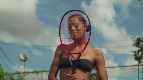 A tennis player, a young girl, clad in a thong bikini