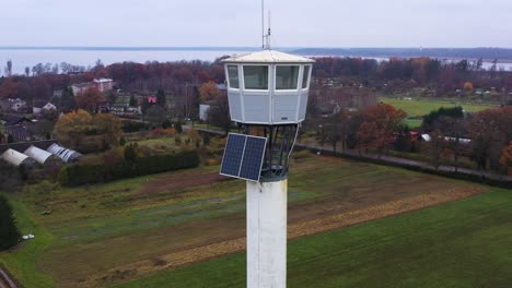 old fire lookout tower with solar panels, parallax drone view