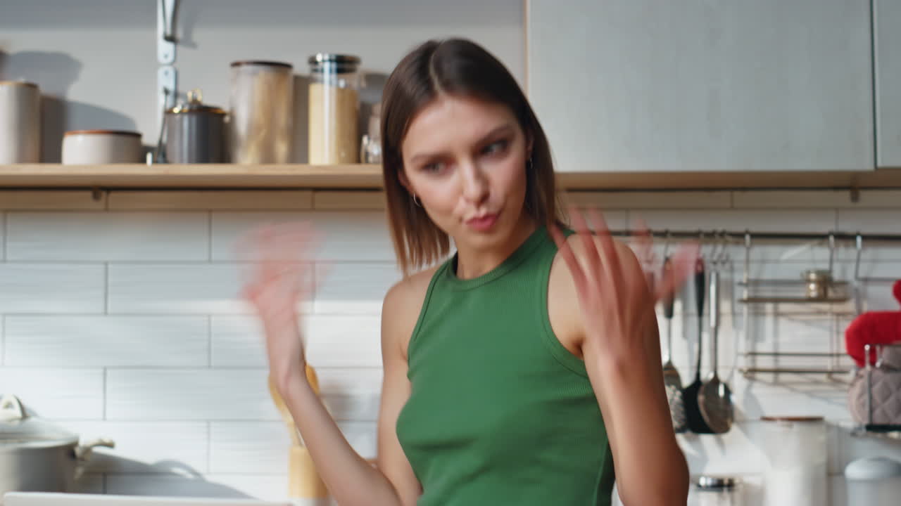 Woman in kitchen with laptop