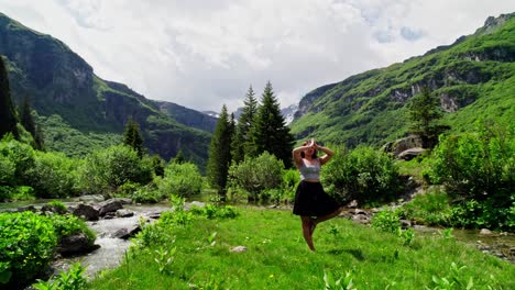 focused woman practicing yoga in green swiss alp setting