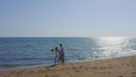 couple and family walking on the beach