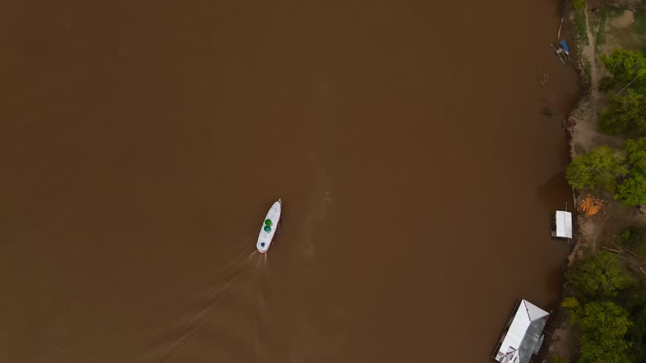 Aerial top down ship sailing in Brown waters of Amazon River, Rain Forest Landscape at Manaus Brazil