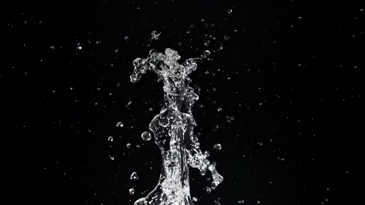 Klares Wasser spritzt in Zeitlupe nach oben auf schwarzem Hintergrund