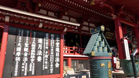 visitors explore a historic shrine with red structures