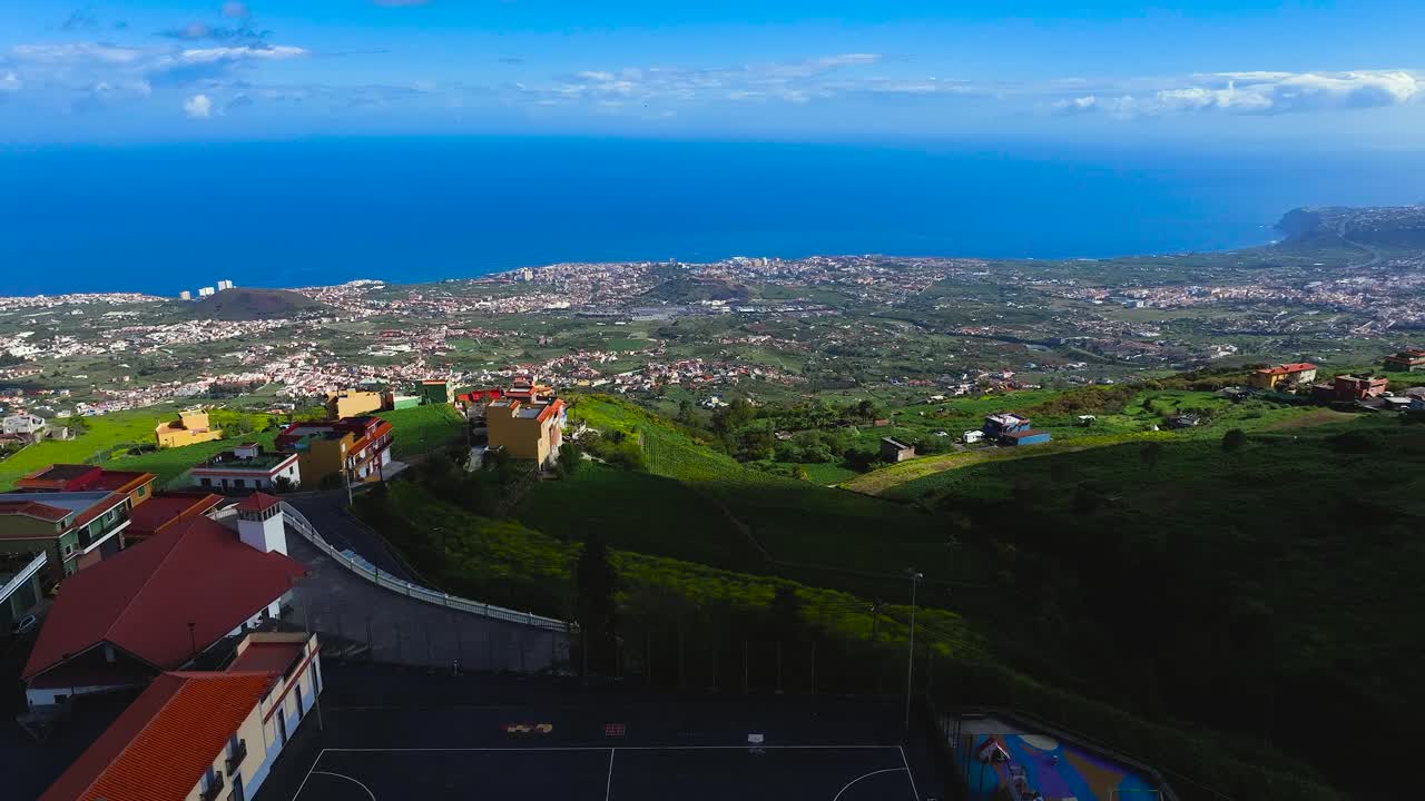 Puerto de la cruz coastline from benijos, showing houses and greenery, aerial view