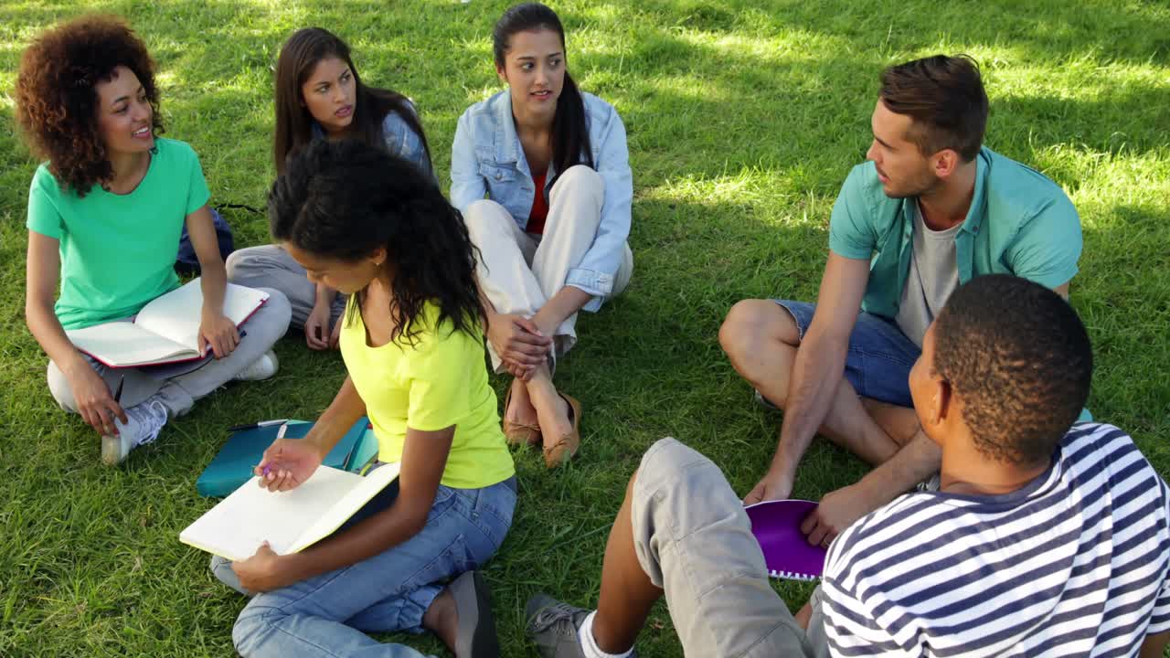 Smiling students chatting together outside on campus
