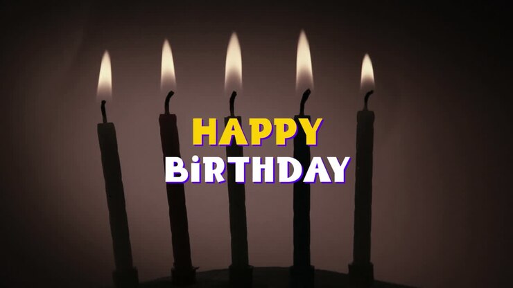 Happy Birthday written over lit candles