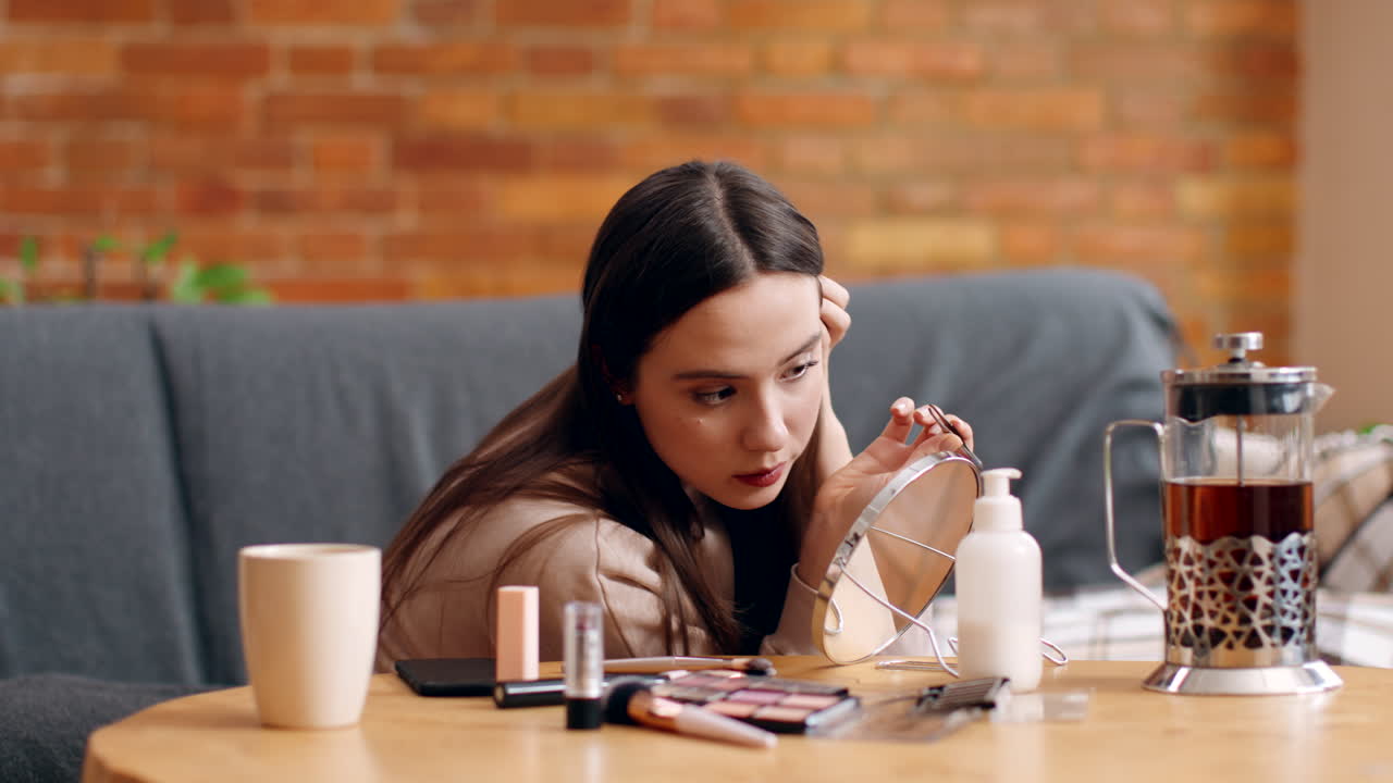Woman applying makeup at home
