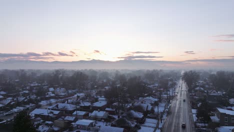 Inversion-fog-covers-suburbs-of-Salt-Lake-city-utah-as-sun-rises-slowly-over-mountain-peaks-in-distance