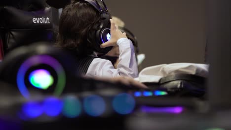 In-the-background-kids-with-rgb-headphones-plays-online-in-gaming-pc's