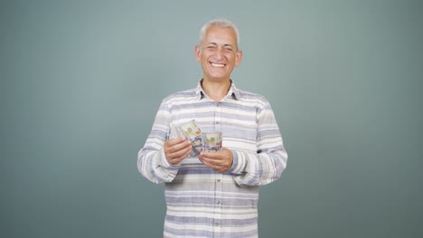 man counting money looking at camera.