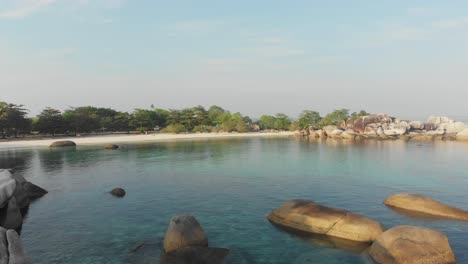 famous tanjung tinggi beach at belitung during sunrise, aerial