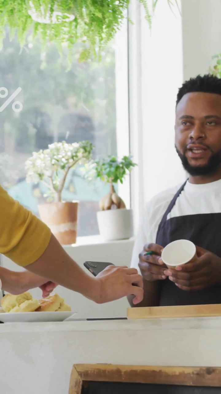 Male Barista Interacting with Customer for Digital Payment in Cafe