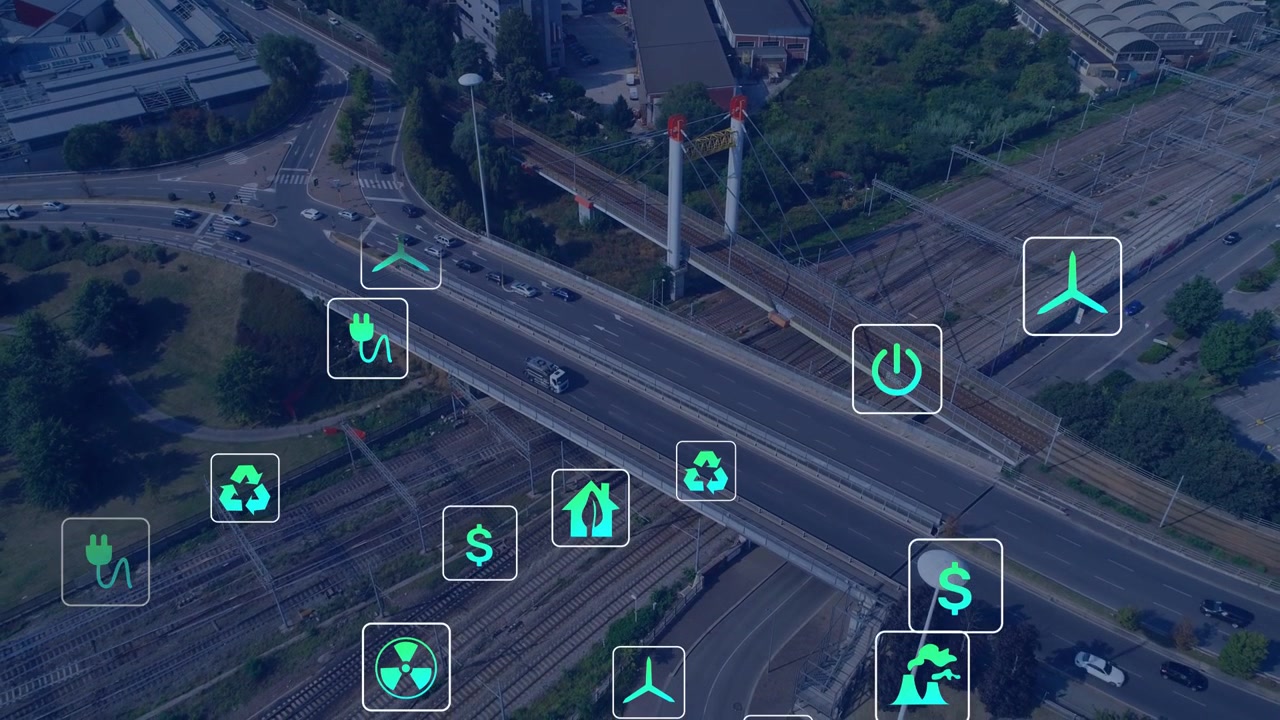 Displaying highway bridge carrying cars, truck over rail yard at day, teal icons appearing