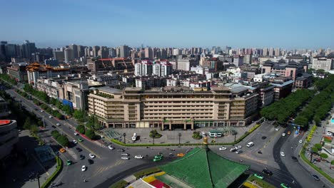 Aerial-view-of-Xi'an's-modern-high-rises-and-busy-streets-on-a-sunny-day,-China