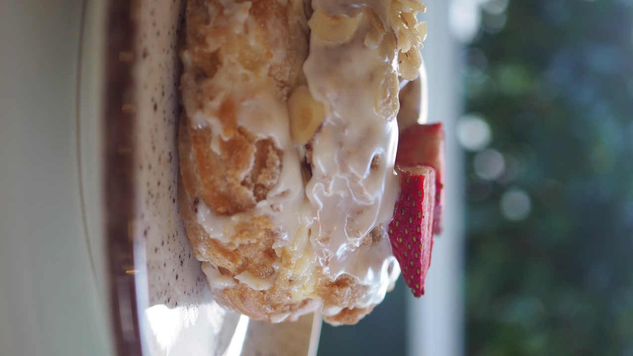 Vertical Video of Glazed Donut with Strawberries and Almonds