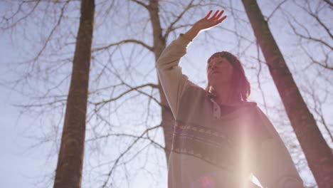 lens flare slo-mo - low angle of a woman slack liner balancing along the strap