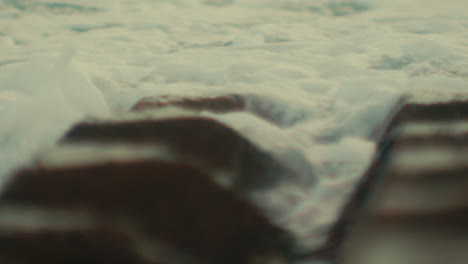 waves crashing on a stone roof