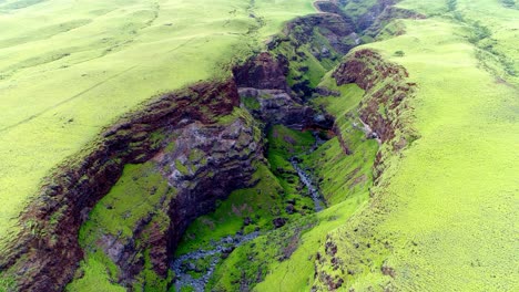 flying over lush green canyon on east side of maui, hawaii