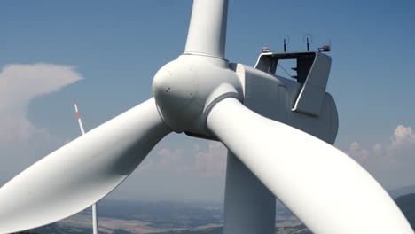 close to the spinning turbine of a windmill