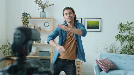 man dancing in living room for online video