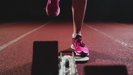 close-up legs in sneakers athletes are running pads on the track of the sports complex and run in slow motion