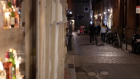 old district at night, blurry bottles in a bar on the foreground, french city